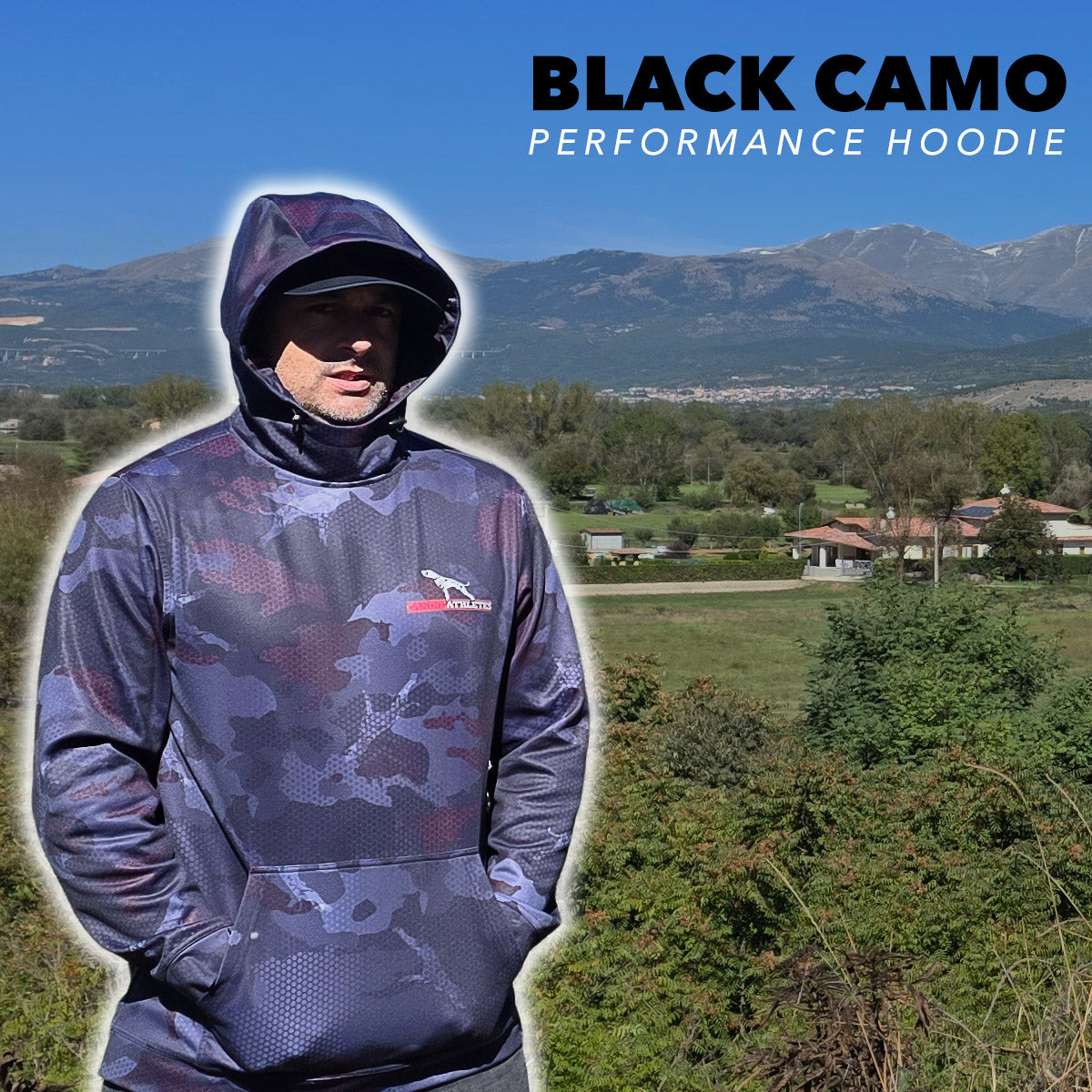 Person wearing a black camo canine athletes dog performance hoodie with mountains and landscape in the background