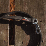 Dog leash with a canine athletes logo on a wooden background