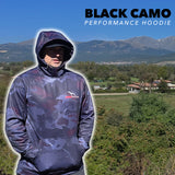 Person wearing a black camo  canine athletes dog performance hoodie with mountains and landscape in the background